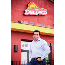 Nachhattar Chandi stands before one of his Del Taco restaurants. 