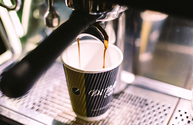 coffee poured into striped cup 