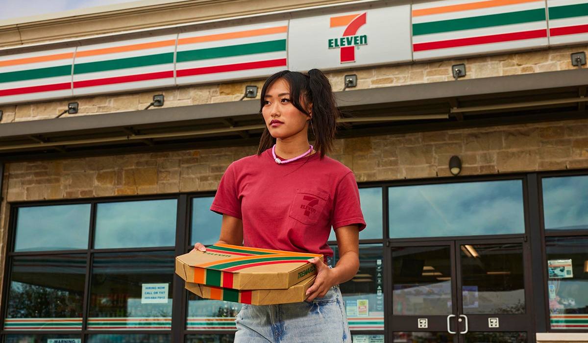 girl-holding-pizza-in-front-of-7-eleven.