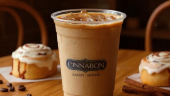 cinnabon-cold-brew-cup-with-cinnamon-roll-in-background.